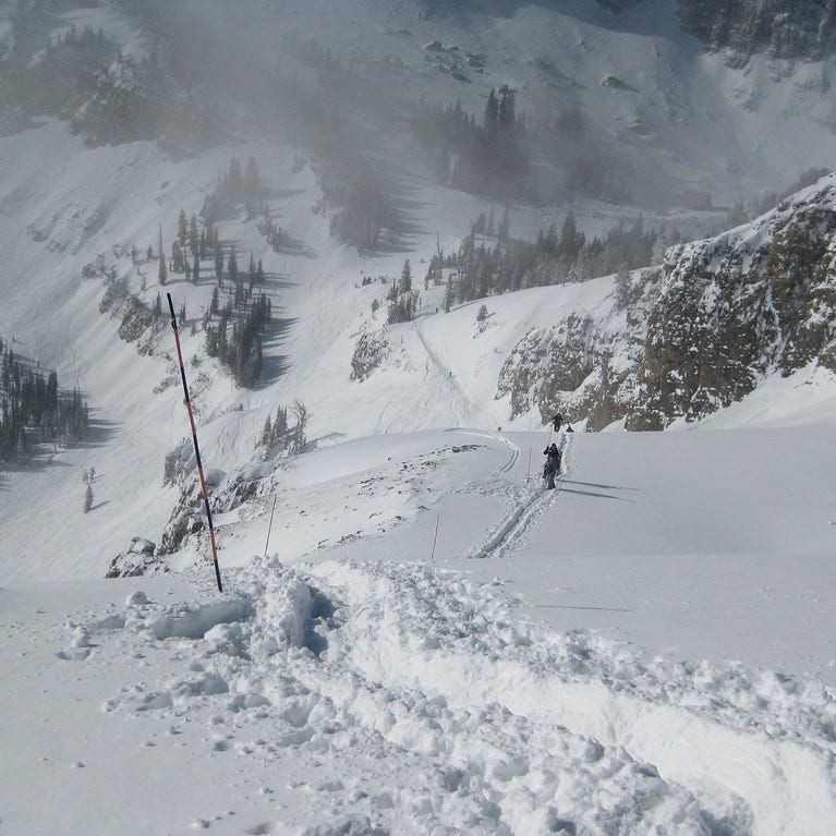 Jackson Hole, Wyoming backcountry skier off trail and the mountain in powdery snow.