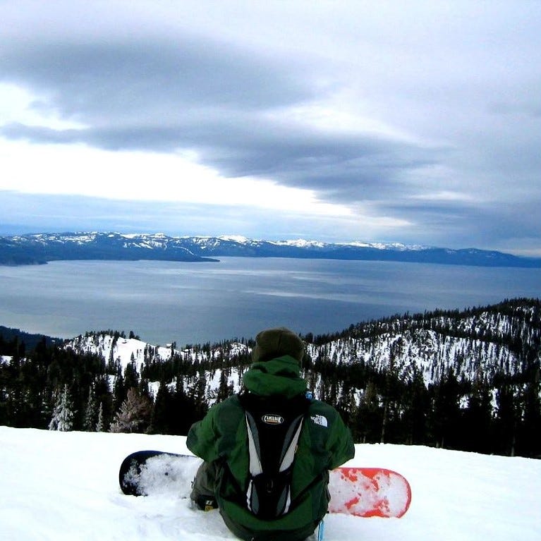 Snowboarder at the top of Heavenly in Lake Tahoe, California/Nevada over looking the lake.