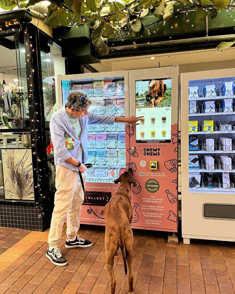 Customers buy dog treats food from a pet vending machine