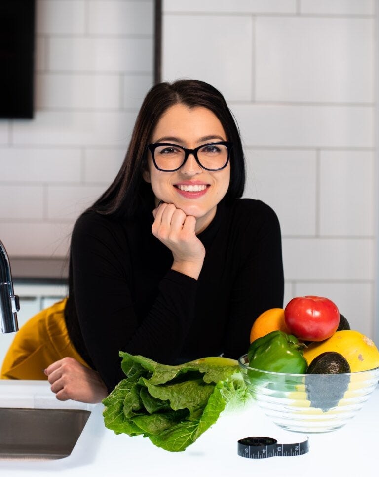 Woman Smiling in the kitchen — Best Ways To Lose Weight — RumboMag — Maintaining a healthy weight is important for overall health and well- being