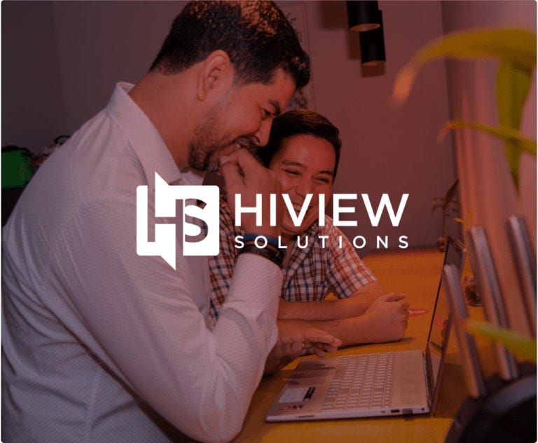 Two men working at a desk with HiView Solutions logo overlayed