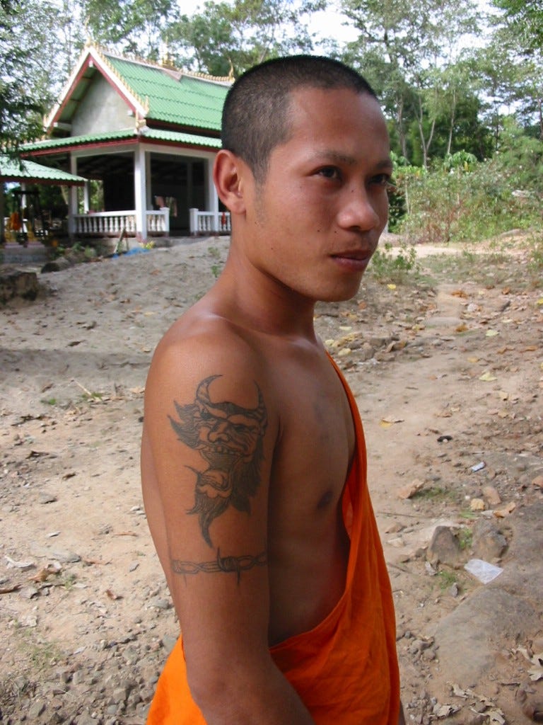 Monks, Baguettes and Rock & Roll (Eight Days in Laos): A Laotion Monk showing his tattoo.