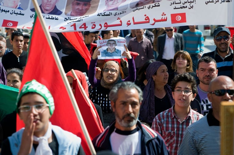 This photo shows women and men mourning their sons who died during the Arab Spring uprisings in Tunisia in 2011.