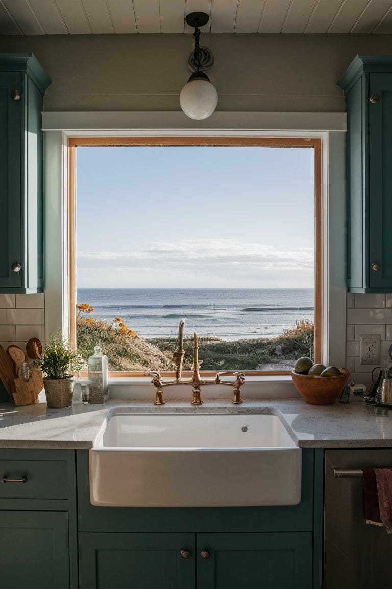 Small coastal kitchen with a large window showcasing a beautiful ocean view, with the sink positioned to face the scenery
