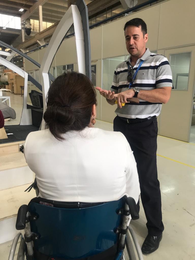 woman using wheel chair talking with a man