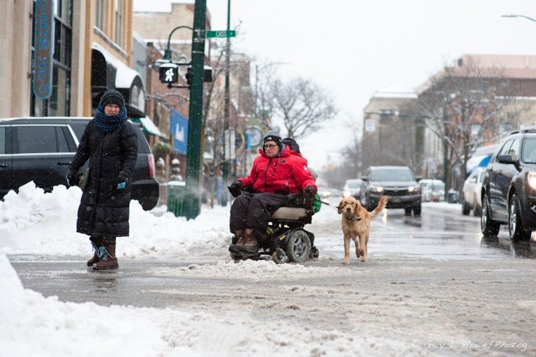 Jeanne in her wheelchair with her dog, Lukie.