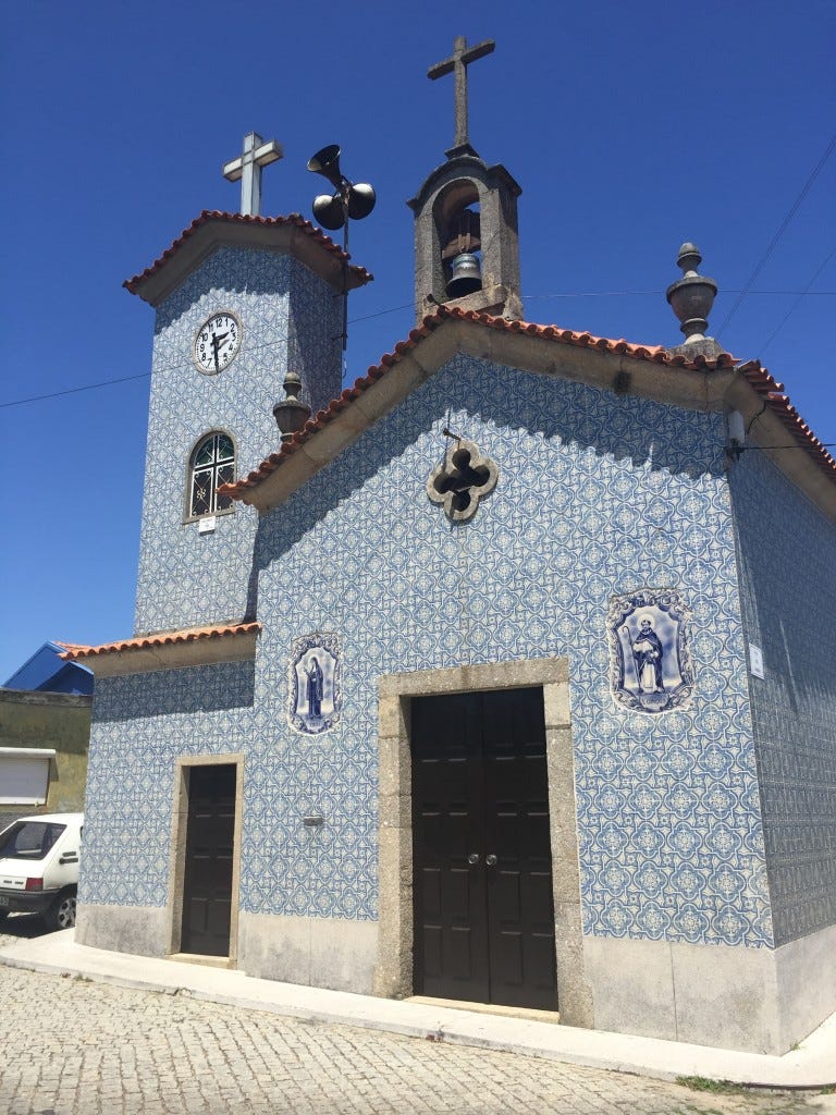 Roadside Chapel bathed in blue and white tiled facade