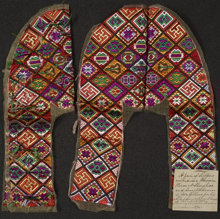 Curio from Isabella Banks’ collection; a pair of 19th century silk slippers from Shanghai with an elaborate pattern of purple, orange, cream, green and red silk