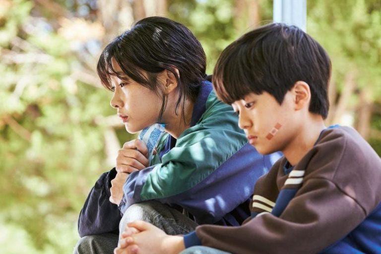 Female main character Sae-Byeok is sitting next to younger brother