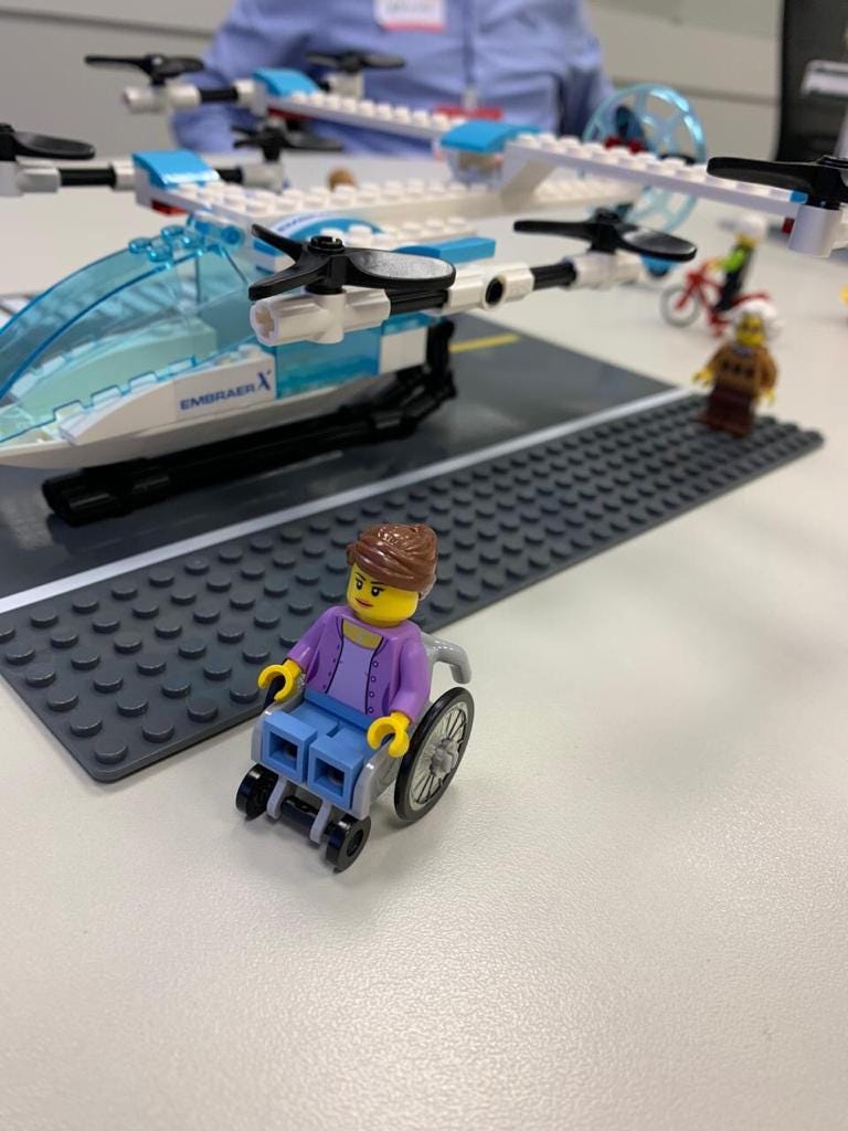 logos showing a flying a vehicle and a wheel chair user