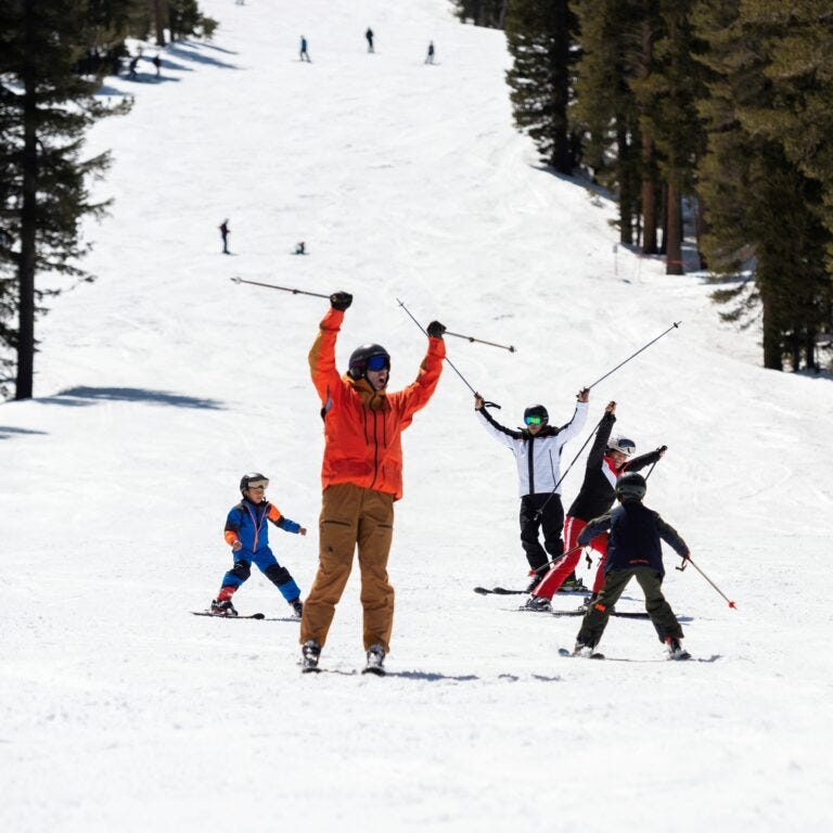 Family skiing down the mountain during Spring Break. Wearing all the tech outer gear and ski and snowboard gear need to have the best family ski and snowboard adventure.