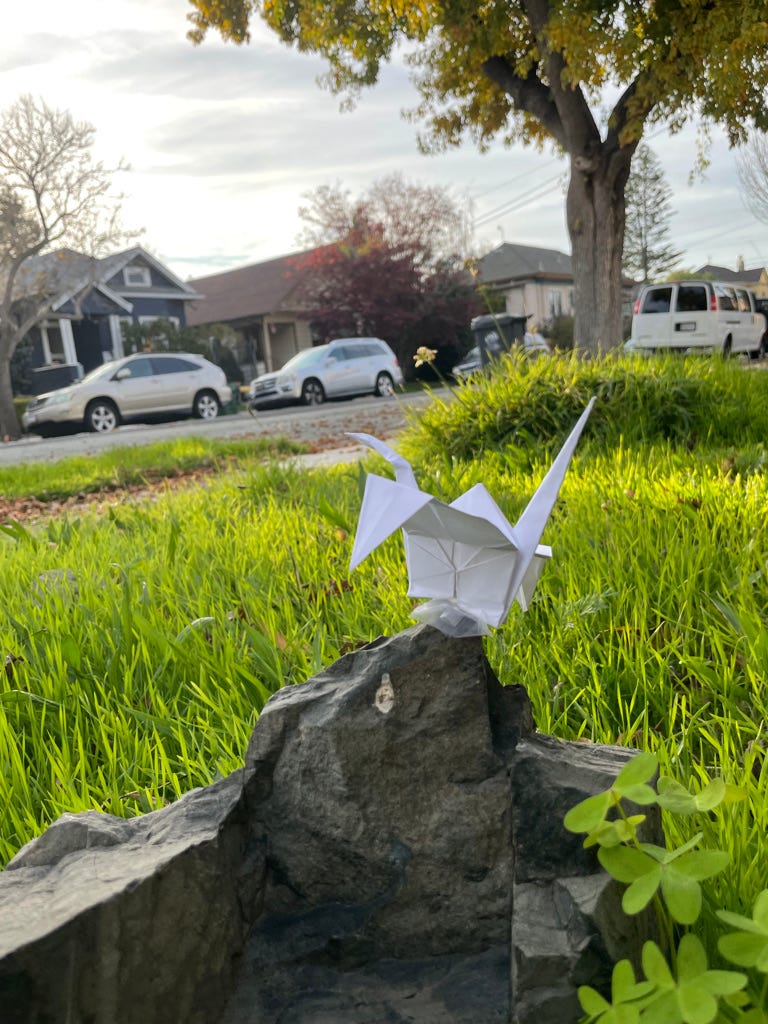 Paper Crane on rock