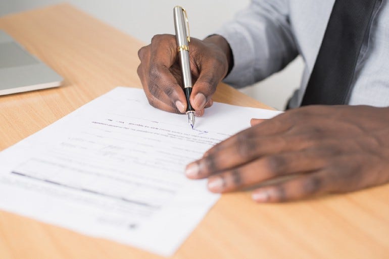 Man writing on a piece of paper