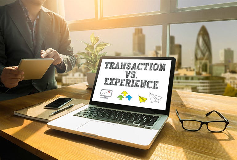 Graphic of computer displaying the text “transaction vs experience”