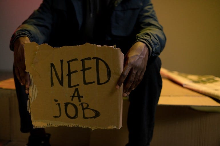 Homeless man with need a job sign