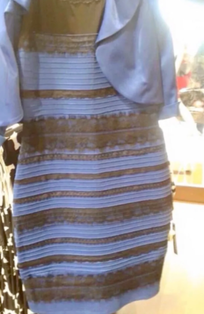 Foto de um vestido azul com listras horizontais pretas. Porém, de acordo com as condições de luz, ele pode ser visto como branco com listras douradas.