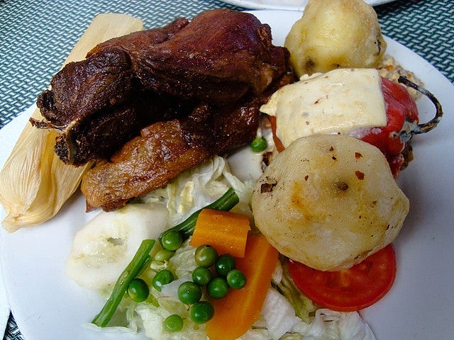 A Peruvian dish of cuy with vegetables