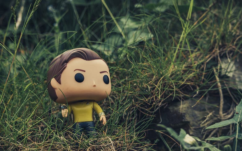 A Star Trek doll in grass