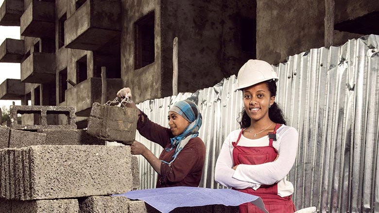 Two beautiful East African females helping with construction site