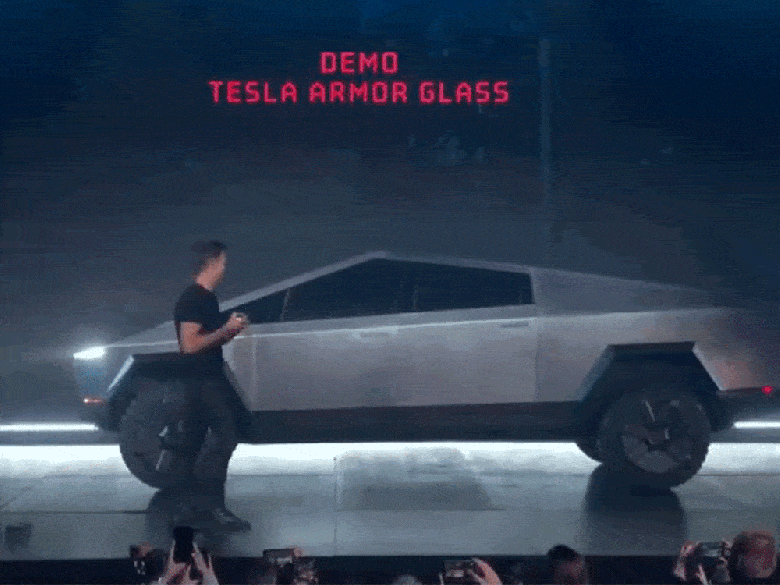 GIF of Tesla employee throwing a ball at the Cybertruck window and breaking it.