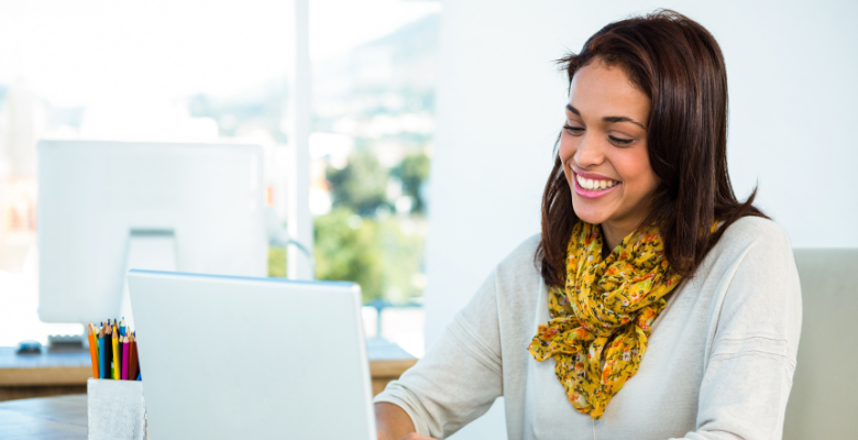 Designer smiling while working on a computer