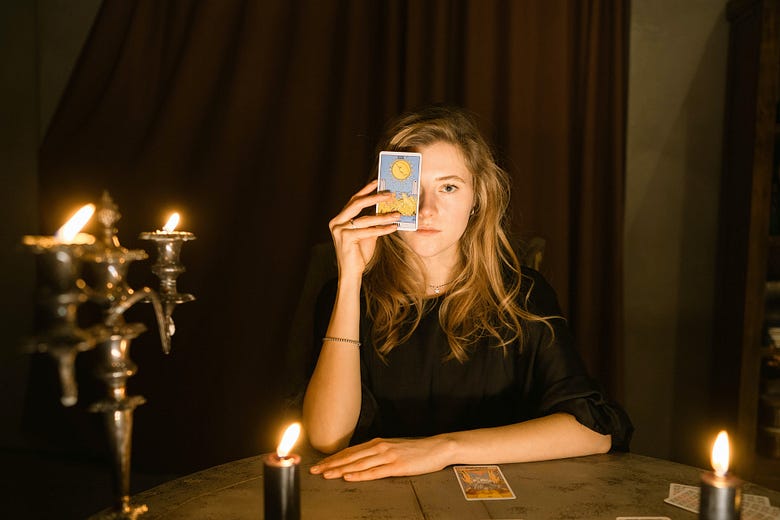 Woman holding tarot card up to her face