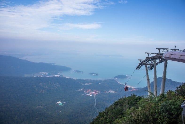 An elevated view of a cable car with the town and ocean below in Langkawi