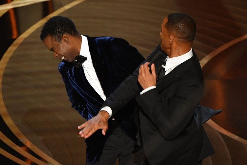 The actor and commediant Will Smith slapping the also actor and commediant Chris Rock on the face.