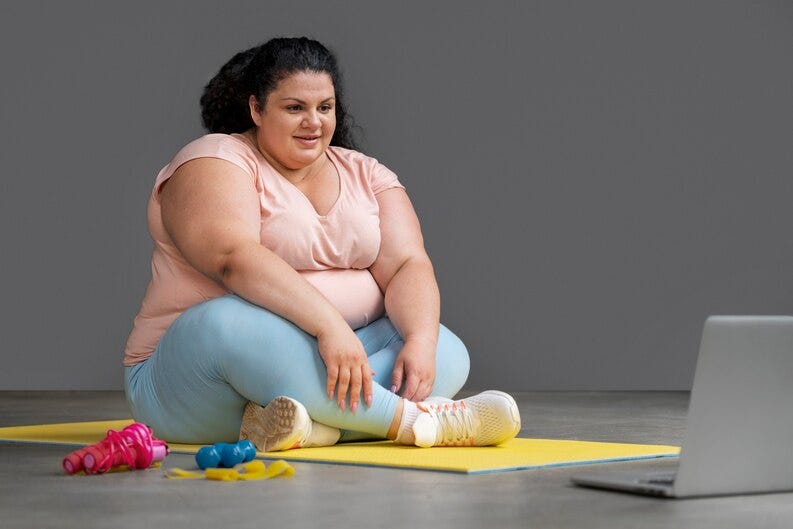 An obese women sitting in front of laptop