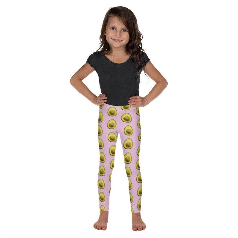 Child wearing avocado print leggings.