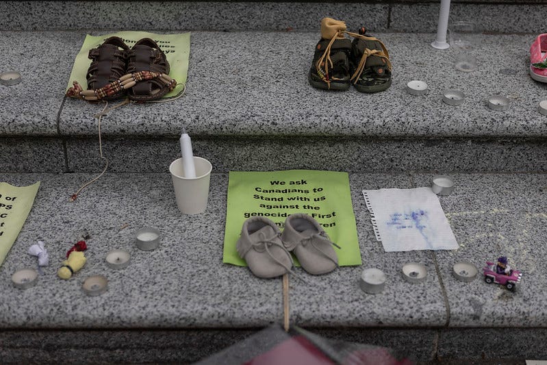 Children’s shoes at a vigil for Indigenous children murdered at Canadian residential schools.