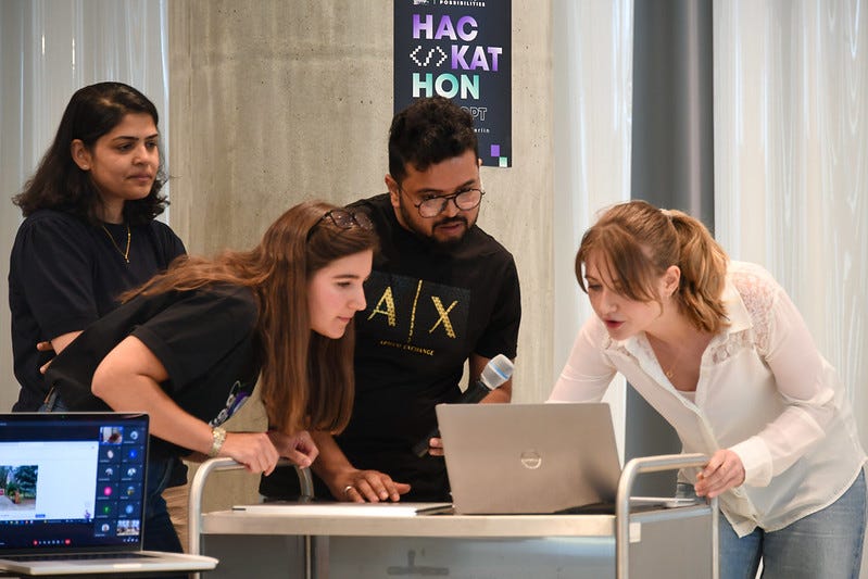 A team presents a demo of their project on stage