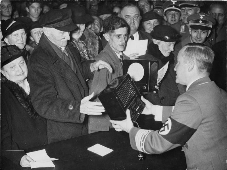 Historic photo from October 1938 showing Gau Propaganda Leader Wächter distributing Volksempfängers to the German public.