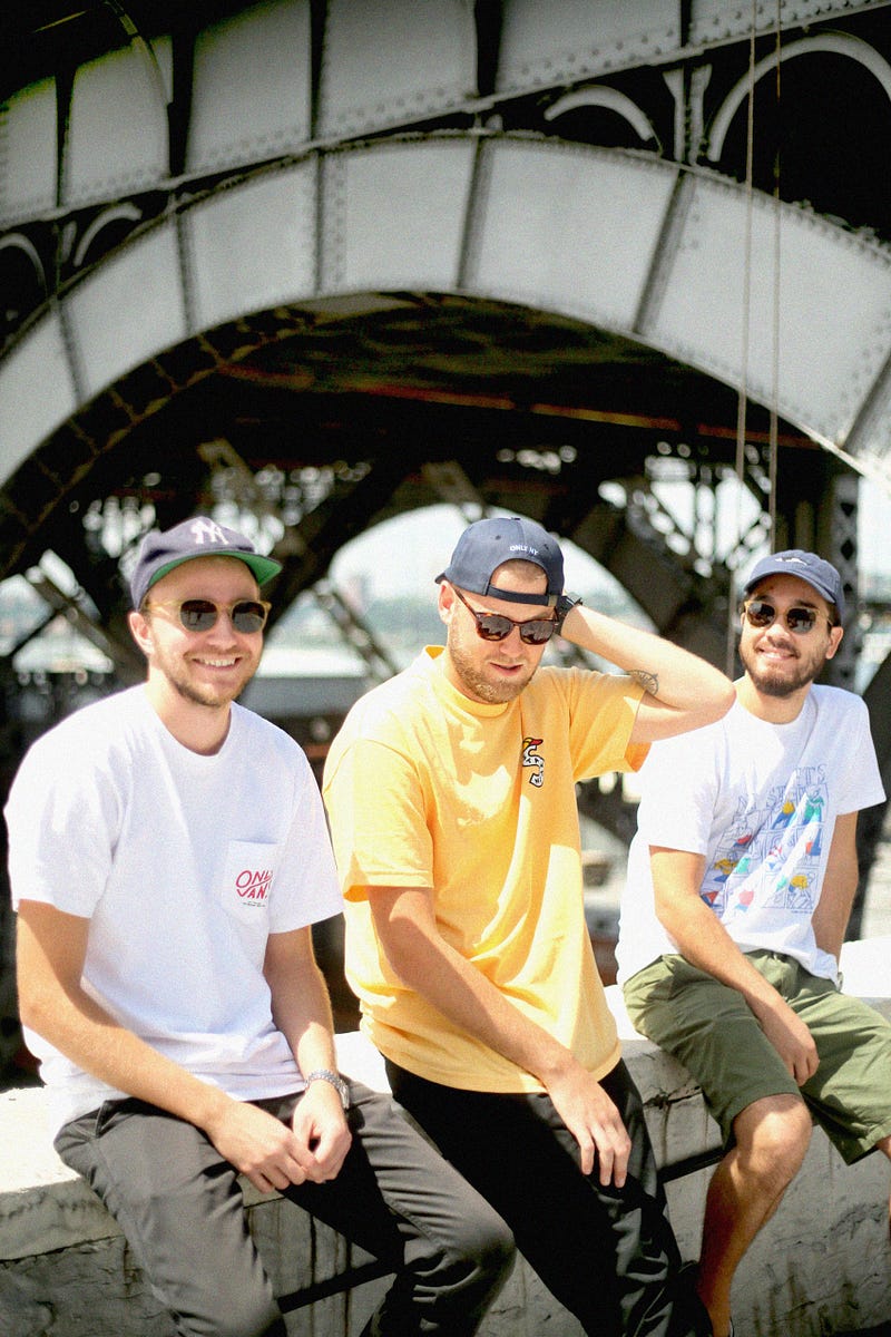 from left to right: Lucas wears Classic Specs Logan sunglasses in Whiskey Crystal, Julian wears the Meritt sunglasses in Brandy Tortoise, and Micah wears the Ashford sunglasses in Whiskey Crystal