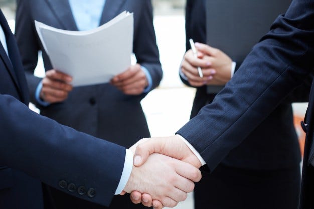 handshake-of-executives-greeting-each-other_1098-1366