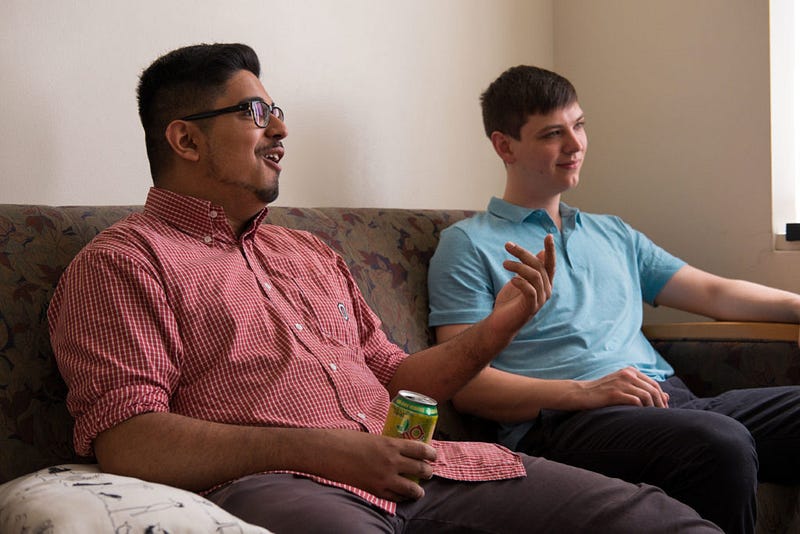 Kush Sharma reacts to a play while watching a League of Legends game between Team Liquid and Team Solo Mid with his roommate Evan Carlsson. 