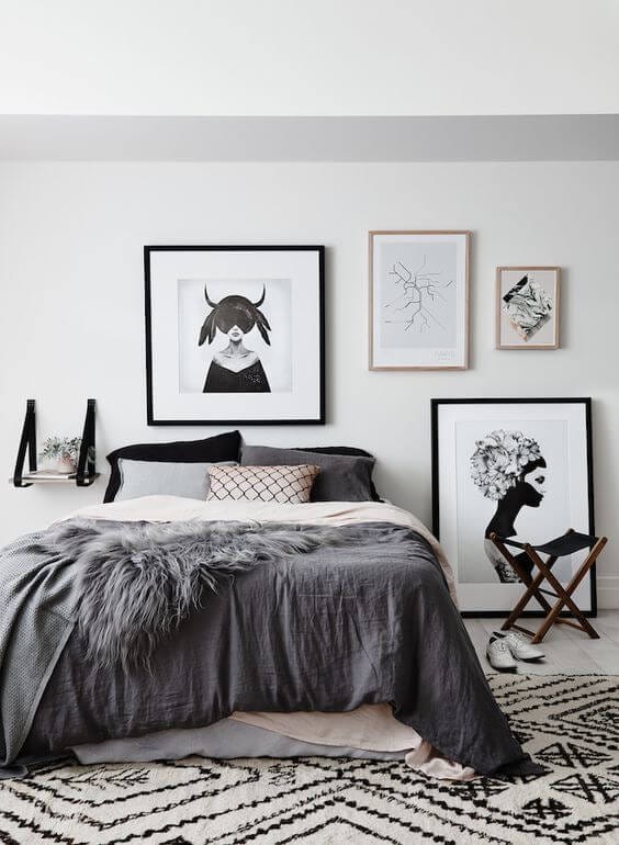 Scandinavian bedroom with dark prints