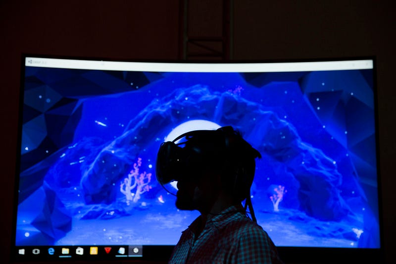 A festival-goer plays with DEEP VR, a virtual reality game that is guided by breath and displayed at Tribeca Storyscapes on April 17, 2016.