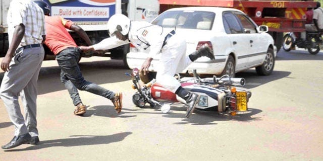 A boda boda rider leaving his bike to escape the police. Credit: The Daily Monitor.