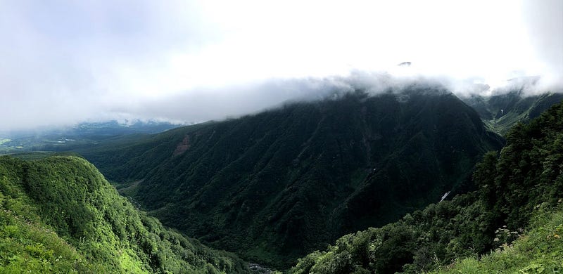 A heavy cloud hangs over a deep crevasse on Chokai-san (Mt. Chokai) near the Hokodate Trailhead.