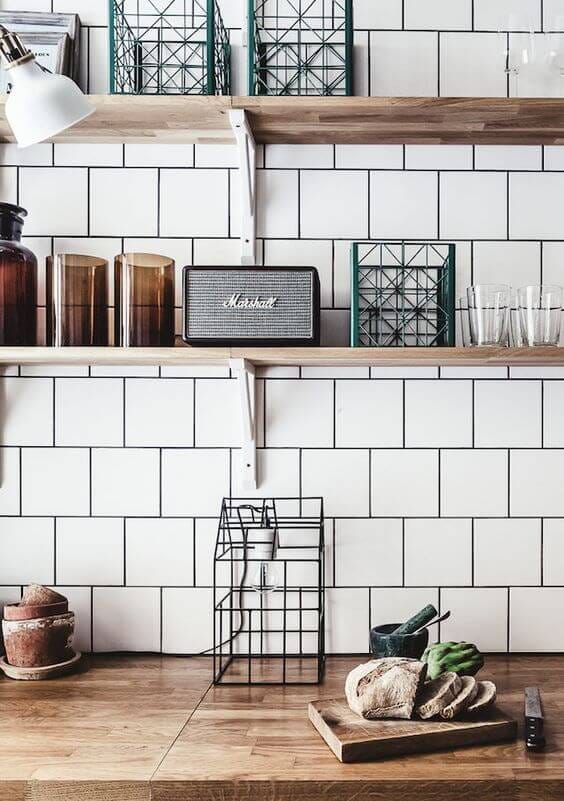 Scandinavian kitchen with white tiles and wood worktops