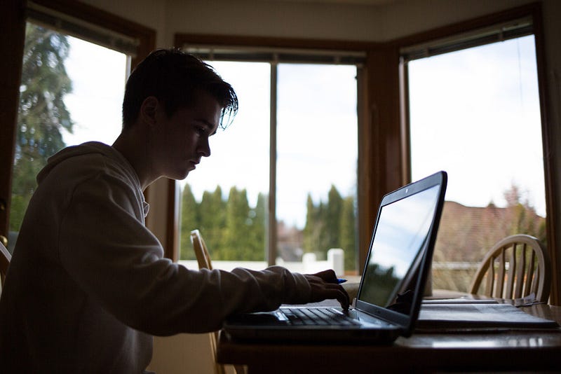 Hansen uses his computer for homework at his home in Mukilteo. To help deal with his disorder, Hansen adheres to some recommendations to help reduce fatigue like avoiding alcohol and nicotine. 