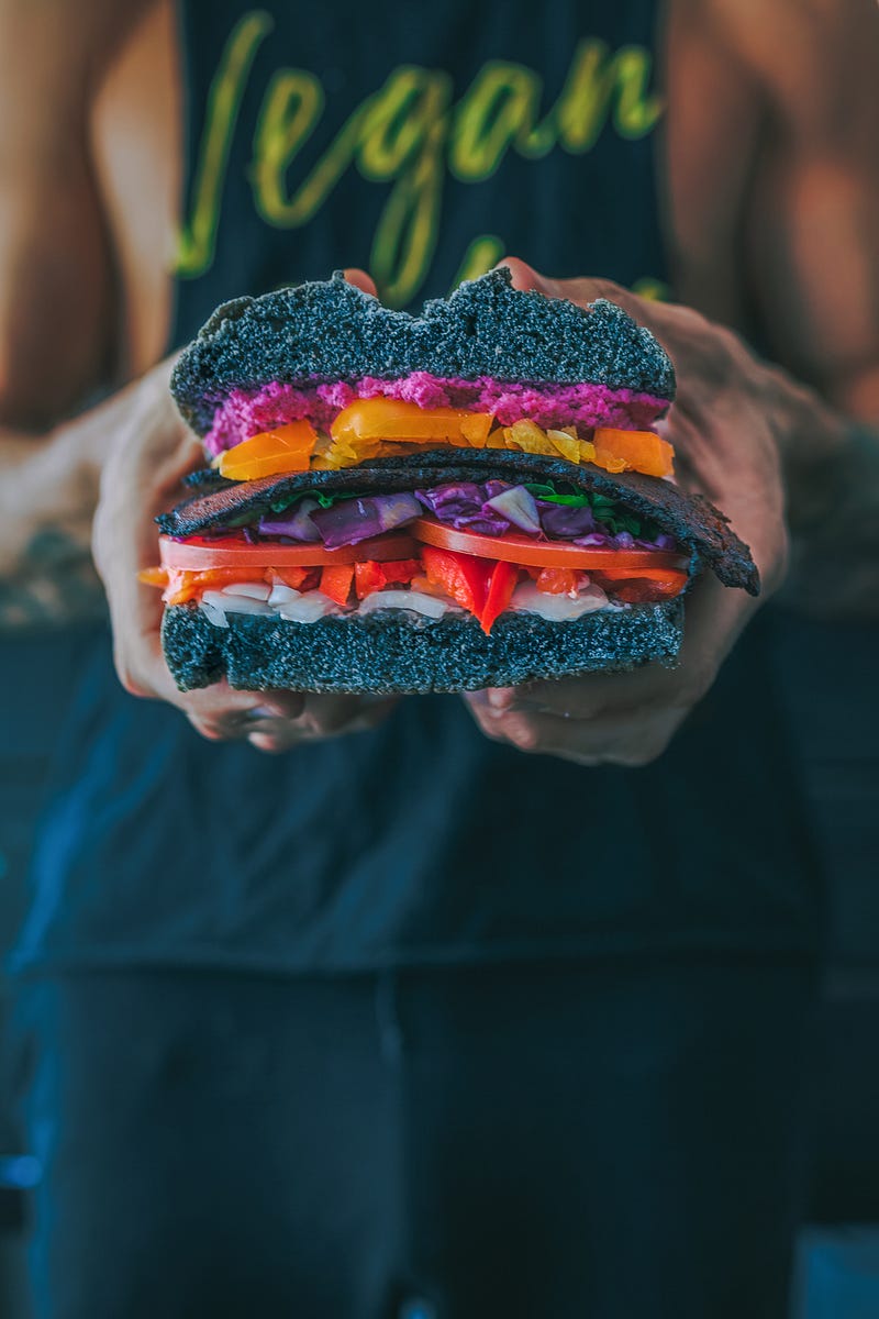 Image of a Vegan holding a Vegan Burger
