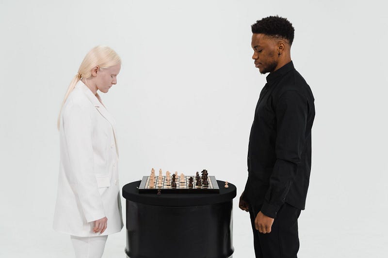 two people standing face to face while playing chess