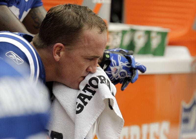 Peyton Manning sits on the sidelines while with the Indianapolis Colts.