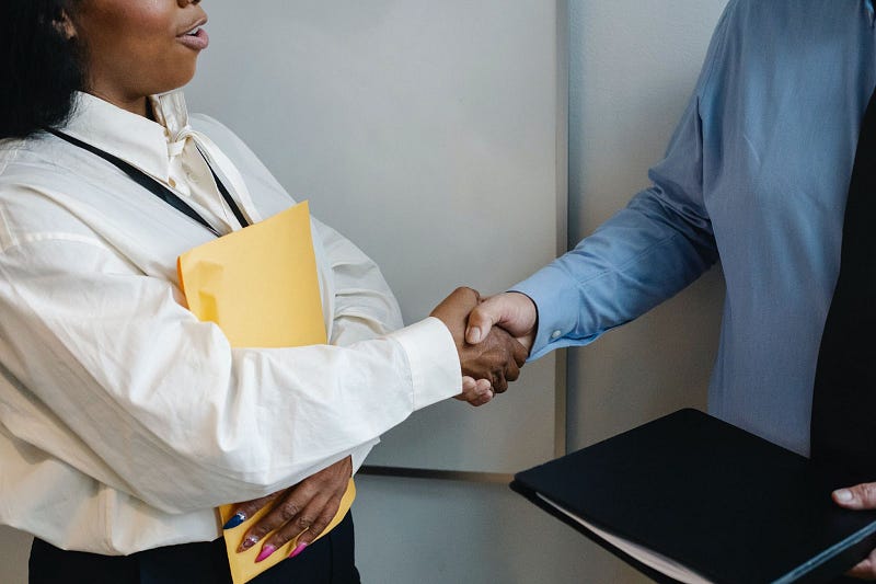 two people shaking hands during employee onboarding