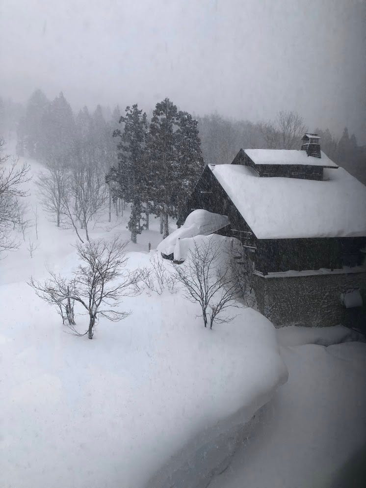 A building under literal mountains of snow where the Onsen (hot spring) of Tsutaya Ryokan is in Nishikawa, Yamagata Prefecture.