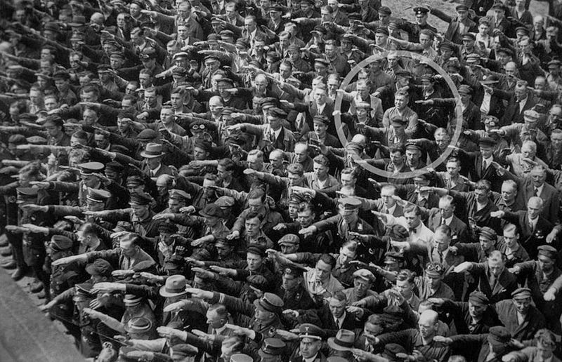 A lone man refuses to do the Nazi salute, 1936.
