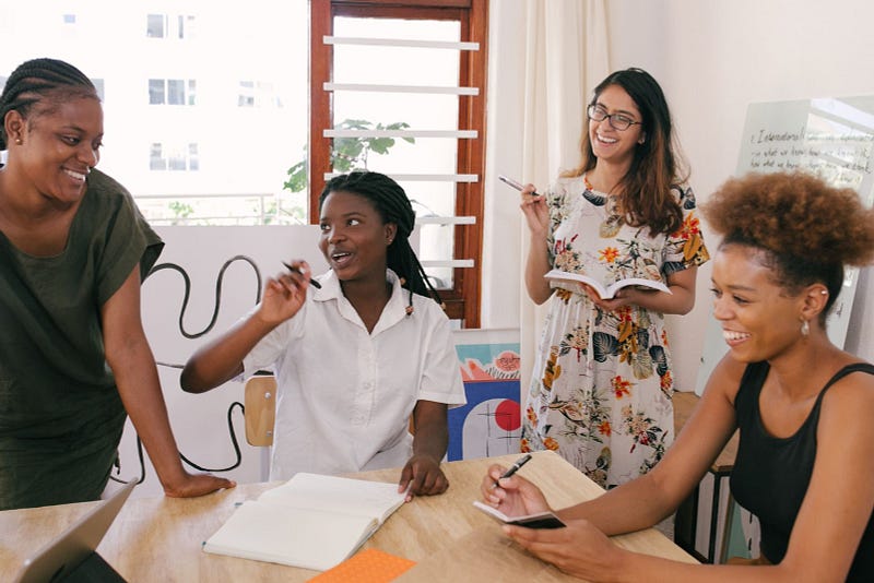 team of women working on a project with time card calculator