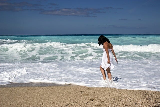 woman loving life at the beach